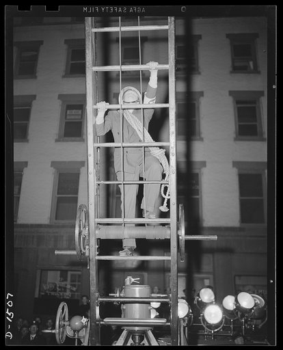 Civilian protection. Here's one volunteer who asks no questions. He's starting to climb into a danger area where his aid is vitally needed. He's bound for the roof of a building which has been struck by several incendiary bombs, where he will work with other volunteer auxiliary firemen to keep the d