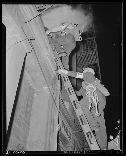 Civilian protection. Members of the auxiliary firemen's group of the office of civilian defense are mounting a short ladder to cope with an incendiary blaze that has been set in an upper story. Auxiliary firemen do not attempt the long ladders of the regular fire forces, but are taught the use of sh