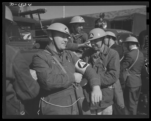 Civilian protection. The "alert" had been sounded and members of a road repair squad don their work clothes and prepare to go forth where they are summoned to restore traffic flow