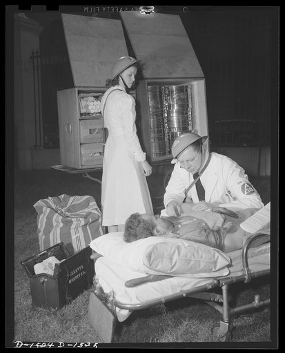 Civilian protection. An emergency unit gives first aid in the field and examines the victim of a fallen bomb. After treatment, he will be quickly evacuated to the nearest hospital or bandaged and turned over to an emergency housing unit. The "M.D." next to the caduceus on the doctor's armband indica