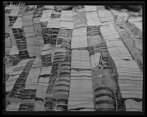Waste paper. Outdated telephone directories are a good source of the paper packing so badly needed today for shipment of defense and lend-lease goods. This pile of directories is in the stock room of a Philadelphia paper mill, which will make pasteboard packing out of it