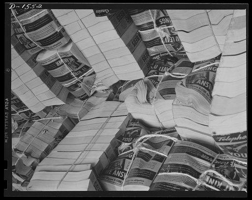 Waste paper. Outdated telephone directories are a good source of the paper packing so badly needed today for shipment of defense and lend-lease goods. This pile of directories is in the stock room of a Philadelphia paper mill, which will make pasteboard packing out of it