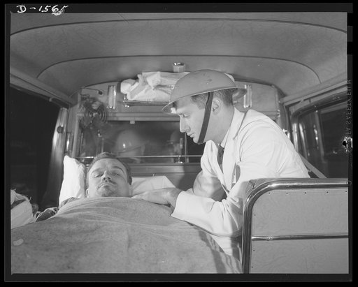 Civilian protection. Victim of a bomb raid is rused to hospital by a medical corps