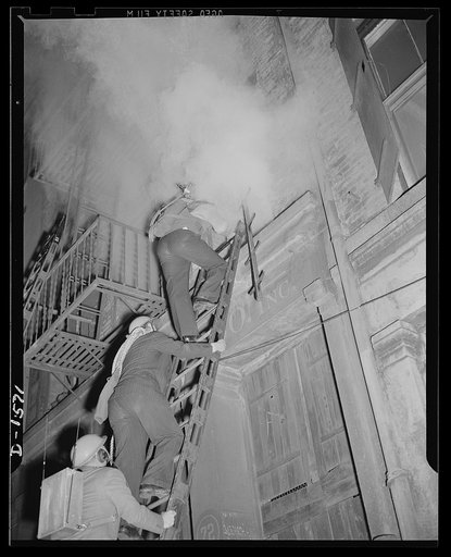 Civilian protection. Fully equipped to cope with any situation they may encounter these New York City volunteer auxiliary firemen put on a demonstration of the matter in which they would handle the damage caused by an incendiary bombing attack. An incendiary bomb has fallen through the roof of this 