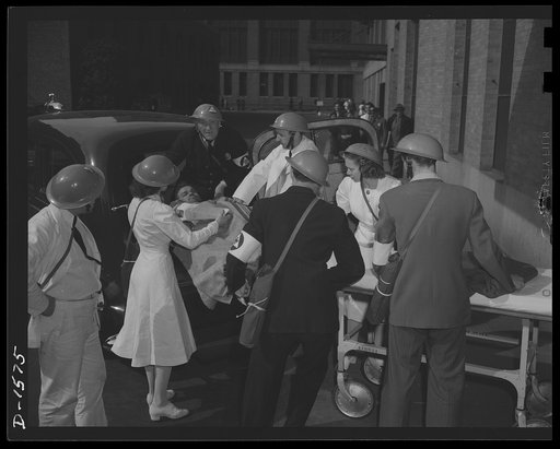 Civilian protection. The victim of a bomb raid is received from the casualty clearing station at the hospital