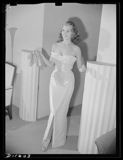 Cotton stockings. Rita Hayworth in a pink and silver lame evening dress designed by the famed Hollywood designer Howard Greer. Her evening hose are of fine crepe lisle of the same spun sugar sheen as the dress