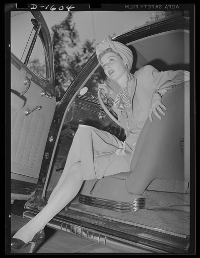 Cotton stockings. Ann Sheridan wears a gabardine suit, skin tone hose with a clock design worked in at the ankle. This photograph demonstrates to some extent, the elasticity and sheerness of the new types of cotton stockings. The cotton hose now being made have more "give" and "twist" than the old t