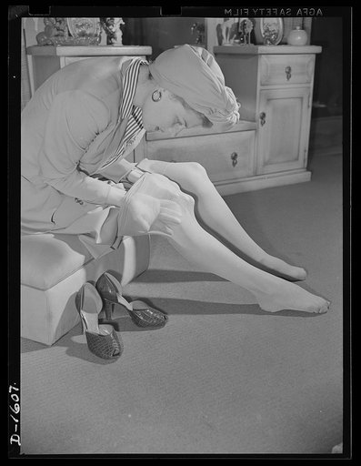 Cotton stockings. Ann Sheridan demonstrates the elasticity and sheerness of the new style of cotton hose