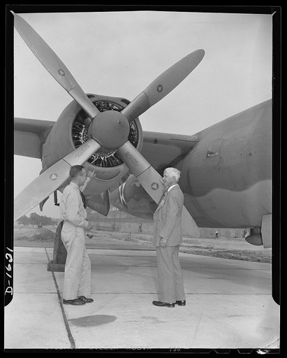 Carl Sandburg, author of the commentary to the Office of Emergency Management (OEM) motion picture, "Bomber" discuuses some of the finer points of the construction of the Glenn L. Martin bomber with chief production test pilot, Roland Lee Sansbury