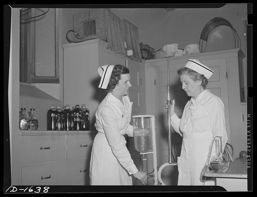 Nurse instructor, left, shows "refresher course" student the new Wagenstein apparatus in use in post operative cases. Retired nurses brush up on latest techniques through this course before again going on active duty