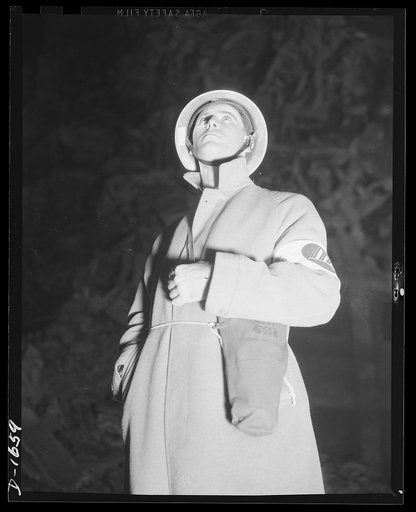 Civilian protection. Scanning the sky for attcking planes is only part of the job this volunteer air raid warden, who is director of air raid protection operations for a block of about 500 people. Four such wardens are named for each section, so that twenty-four hour protection is assured. In the ev