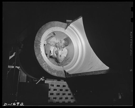 Shipbuilding (Newport News). This craftsman is measuring the rudder bearing for a new battleship. Split hair accuracy is required in fashioning these watertight fittings