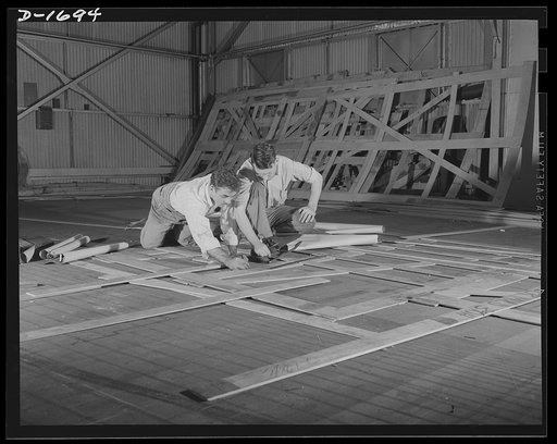 Shipbuilding (Newport News). These are mold loft workers laying out patterns for various parts of naval vessels under construction. These patterns are subsequently transferred to steel