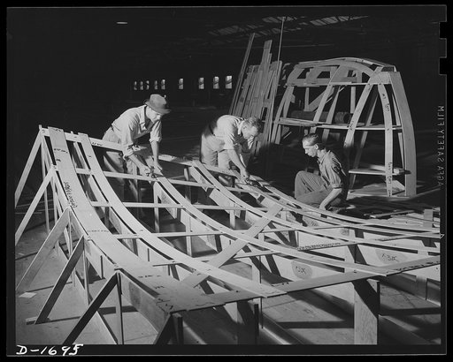 Shipbuilding (Newport News). These are mold loft workers laying out patterns for various parts of naval vessels under construction. These patterns are subsequently transferred to steel
