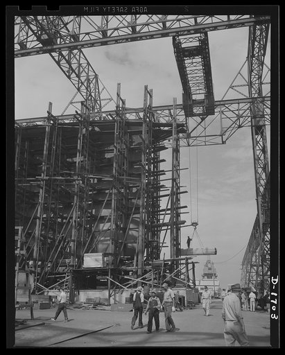 Shipbuilding (Newport News). Through the scaffolding may be seen the prow of a battleship under construction. The Norfolk-Newport News section of Virginia is contributing a large portion of the new tonnage of our rapidly expanding two-ocean Navy
