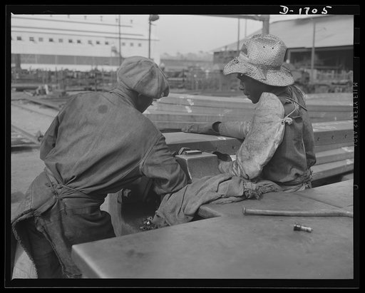 Shipbuilding (Newport News). These two skillful workers are punching rivet holes in the frame of a ship on the ways. Nearly a million rivets were used in large naval warcraft until recently, but steel and weight is now conserved by the use of welded jointures whenever possible