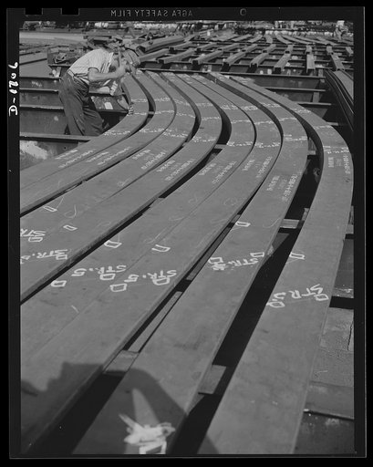 Shipbuilding (Newport News). Thousands of workers contribute thousands of skills in the building of ships for Uncle Sam's growing Navy. This worker is topping punching holes on a ship's frame