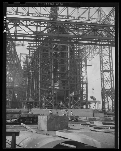 Shipbuilding (Newport News). Through the scaffolding may be seen the prow of a battleship under construction. The Norfolk-Newport News section of Virginia is contributing a large portion of the new tonnage of our rapidly expanding two-ocean Navy