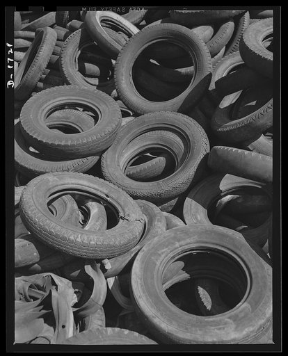 Conservation rubber tires. Scenes such as this become less and less frequent as Uncle Sam pushes his all-out drive to conserve rubber. Many of these discarded tires could easily be reconditioned and used for many thousands of miles. Other discards are immediately baled up and reused by rubber plants