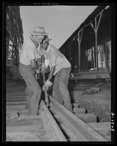 Shipbuilding (Newport News). Transportation is a vital operation in the huge Newport News Yard, where more than 36,000 workers are employed. These two workers are shown laying his tracks for a new railroad spur, which will carry materials right to the building ways where four cruisers and a large ba