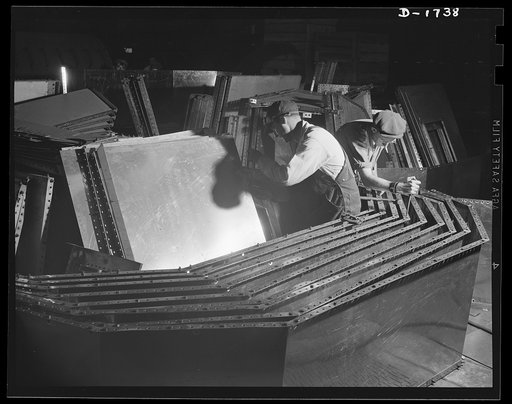 Shipbuilding (Norfolk Navy Yard). These workers are punching stainless steel for use in galleys and mess rooms in naval craft under construction at Norfolk