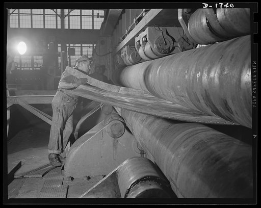 Shipbuilding (Norfolk Navy Yard). Tedious and exacting is the work of this highly skilled machinist. He is shaping a ship's plate, a difficult operation which must be accurate to the "nth" degree