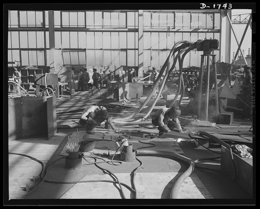 Shipbuilding (Norfolk Navy Yard). Hundreds of skilled workers are engaged in the welded shop. Welded jointures have many advantages over riveted fittings, and welders are sought in increasing quantities for work on Uncle Sam's growing battle fleet