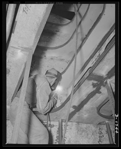 Shipbuilding (Norfolk Navy Yard). The welder is a valuable man in our defense industries. This one is working on the bow section of a new destroyer for Uncle Sam's Navy. Welding insures durability, cuts down weight and means a considerable saving in steel