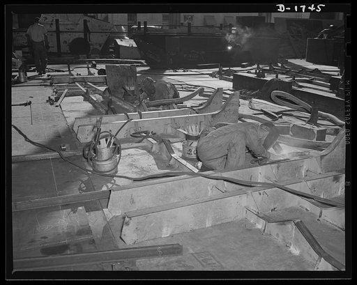 Shipbuilding (Norfolk Navy Yard). Hundreds of skilled workers are engaged in the welded shop. Welded jointures have many advantages over riveted fittings, and welders are sought in increasing quantities for work on Uncle Sam's growing battle fleet