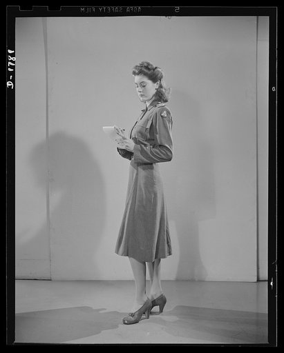 Civilian defense uniforms. Office indoor staff. This girl wears the staff insignia