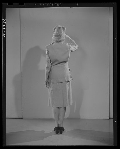 Civilian defense uniforms. Summer "parade." This girl is wearing a messenger's insignia