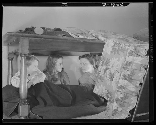 Air raid protection--what to do in your home. This is not the way to spend the evening, but simply a handy place to go if bombs suddenly start falling nearby. A heavy, sturdy table will not only keep off falling plaster that may be shaken down by a nearby burst, but would even help to support beams 
