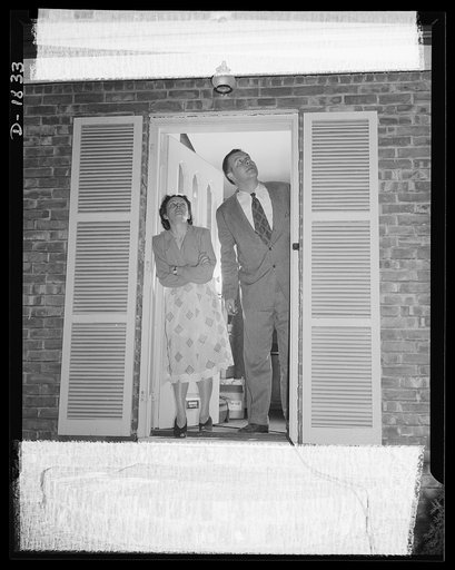 Air raid protection--what NOT to do when alarm sounds. DON'T rush out to look at the planes! Don't look up and certainly don't send a blaze of light forth into the night. What this couple are doing constitutes a mild form of suicide