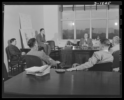 Donald M. Nelson, Chairman, War Production Board, at a staff conference in his office in Washington