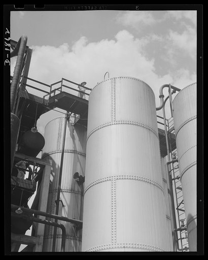 Oil. Vital operations in the refining of lubricants for the war machines of democracy are performed here. These are the solvent storage and surge tanks of the McKean plant of the Quaker State Refining Company, Bradford, Pennsylvania