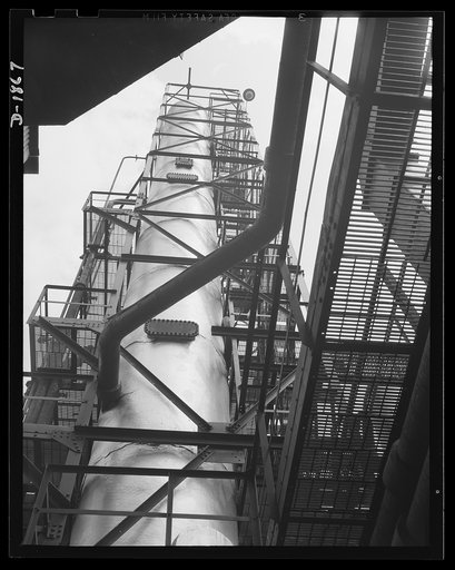 Quaker State Refining Company, Oil City, Pennsylvania. Here is the crude-stripping tower, one of the many steps in the manufacture of the lubricants of war. Thousands of gallons of crude oil pour through this tower daily; it is here that impurities are extracted. Only the best oil is used for milita