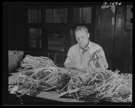 Barrage balloon manufacture. Rope work. Splicing and handling ropes is a vital part of barrage balloon manufacture, and requires unusual skill to make ropes lie smoothly, pull uniformly, avoid chafing the fabric, or bunching after the balloon is fully inflated. An early step in the work is shown her