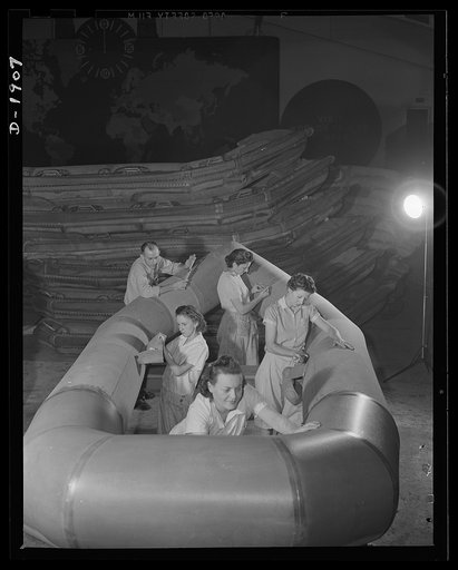 Assault boat Production. Building assault boats for U.S. Marine Corps. Boats are fitted with various pockets for carrying emergency rations and other equipment. This picture shows outer tube of boat completed before bottom has been applied. Goodyear, Akron, Ohio
