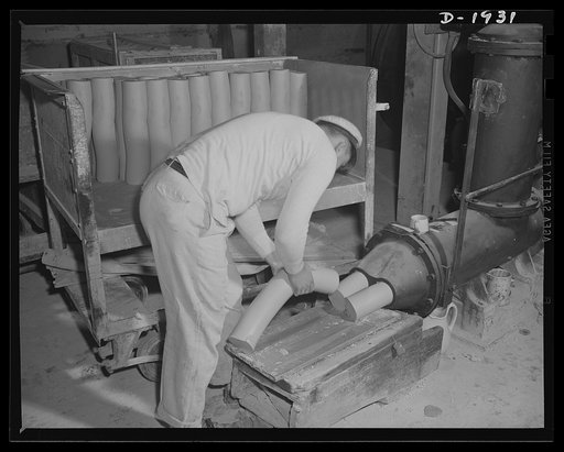 This is the exit end of a pug mill which prepares the plastic clays used in forming various articles of chinaware. Shenango Pottery Works, Newcastle, Pennsylvania