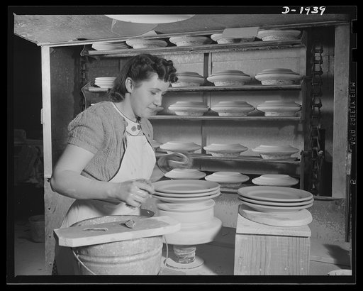 Trimming the edges of plates for the Army Quartermaster. Shenango Pottery Works, Newcastle, Pennsylvania
