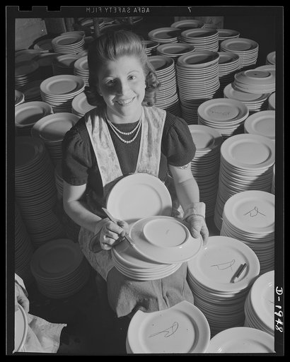 Removing firing marks from the backs of dinner plates for the crew's mess of the Navy. Shenango Pottery Works, Newcastle, Pennsylvania