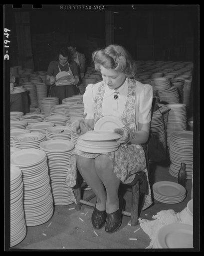 Removing firing marks from the back of a dinner plate for the Army Quartermaster. Shenango Pottery Works, Newcastle, Pennsylvania