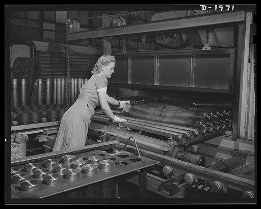 Three-inch A.A. cartridge cases. Loading antiaircraft cartridge cases into a stress-annealing furnace to make them soft, uniform and ductile, ready for succeeding machine operations. The equipment possessed by this big Midwest plant was well suited for producing these cases in large volume