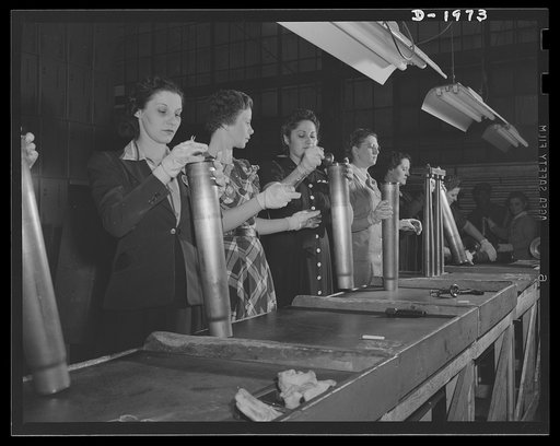 Three-inch A.A. cartridge cases. On the inspection line of a large Midwest plant turning out antiaircraft cartridge cases the primer hole is carefully checked and other features of the cases examined