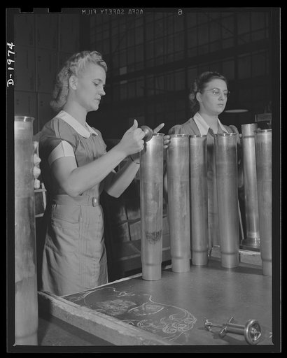 Three-inch A.A. cartridge cases. The primer hole of every antiaircraft cartridge case made by a Midwest plant is carefully inspected to insure that the loading and for use against enemy planes.
