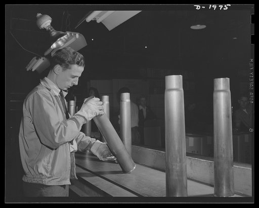 Three-inch A.A. cartridge cases. Antiaircraft cartridge case produced in a large Midwest metal working plant go through the Army ordnance inspection before they are accepted