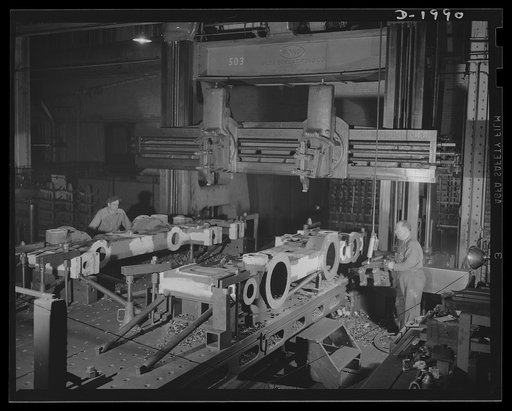 Steel mill equipment. Small parts and large ones--automatic machine tools and the old grind stone, somewhat modernised--all find a part in our war production program. These workers finish off one of the many parts that go to make up the equipment that helps to turn out the steel required for tanks a
