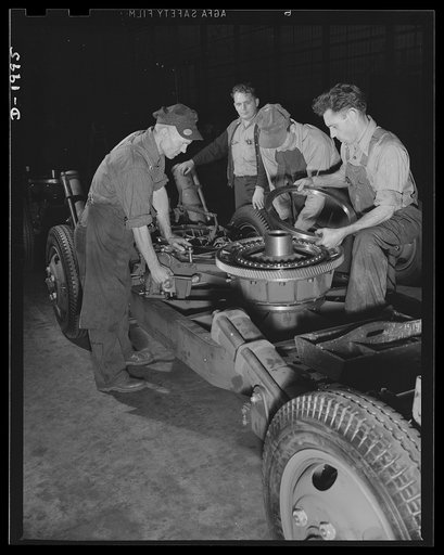 Antiaircraft gun carriage. The traversing bearing is installed on a thirty-seven millimeter antiaircraft gun carriage as it moves down the assembly line. These precision-built ball bearing installations are vitally important, for on their unfailing smooth action depends the gunners' ability to follo