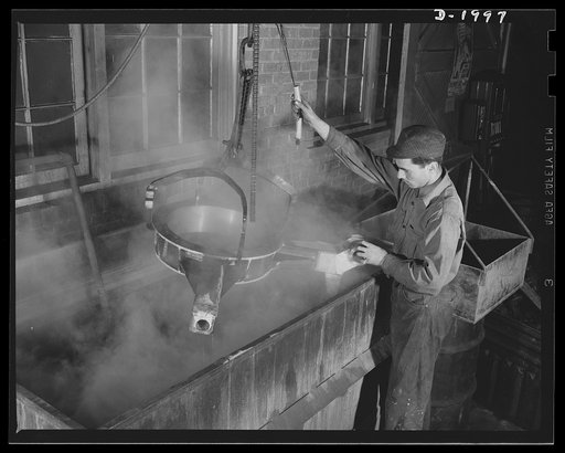 Antiaircraft gun carriage. The leveling yoke for a thirty-seven millimeter antiaircraft gun carriage is cleaned in this bath before being painted. This yoke puts the gun on an even keel no matter what type of terrain the carriage rests upon. War program production scene in a Pennsylvania heavy indus