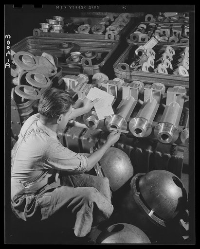 Antiaircraft gun carriage. Inspection of a thirty-seven millimeter antiaircraft gun carriage parts. With 300-plus-mile-per-hour planes for targets, antiaircraft assembly must be a precision instrument to permit the gunner to keep on his target. Inspection is as rigid as in instrument manufacture. Wa